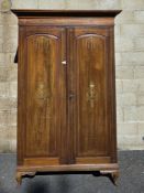 Edwardian mahogany inlaid wardrobe, the moulded cornice over two panel doors opening to a hanging
