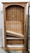 Modern pine tall bookcase, the moulded cornice over reeded sides with five shelves on a plinth base,