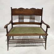 Late 19th/early 20th century Arts & Crafts oak two-seater settee having a deep carved toprail and