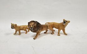 Beswick pottery models of a lion, lioness and cub, printed marks, 22cm long (3)