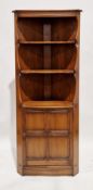 Ercol Mural Elm Golden Dawn tall corner cabinet comprising two open shelves over a single panel door