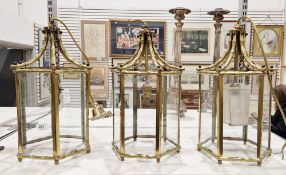 Set of three gilt brass and glass hall lanterns of hexagonal pagoda form with faux bamboo