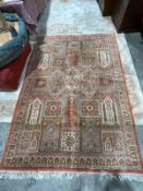 Green ground rug with three geometric cross medallions on geometric floral field, multiple geometric