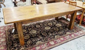 Substantial oak dining table by the Royal Oak Furniture Company, the plank top on four thick