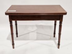 Early 19th century mahogany fold-over tea table of rectangular form, on turned tapering ringed legs,