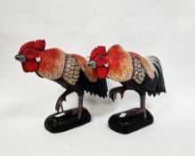 Pair of Folk Art style brightly painted wooden carved models of cockerels, 39cm long