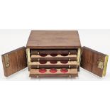 Mahogany collector's coin cabinet, the two doors opening to four drawers fitted with circular coin