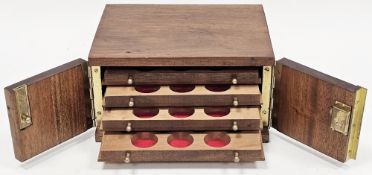 Mahogany collector's coin cabinet, the two doors opening to four drawers fitted with circular coin