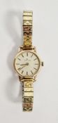 Lady's Garrard 9ct gold bracelet watch, the circular dial with baton markers, on gilt metal