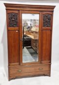 Edwardian walnut wardrobe, the moulded cornice over single mirrored door flanked by panels with