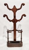 Victorian mahogany four-branch hallstand having nine turned wooden coat hooks, above an open stick