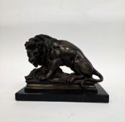 In the manner of Antoine-Louis Barye, bronze model of a lion hunting a boar on a black marble