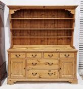 Pine dresser in the 18th century style, the top with three plate shelves over four frieze drawers
