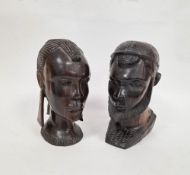 Two African ebony carved busts, one of a male and the other a female, 27cm high