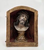 Composite bust of St. Cristo de Limpias, 34cm high contained in a wooden open fronted barrel back