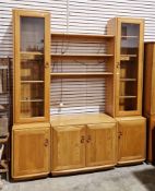 Ercol Windsor 1057 light elm modular wall side cabinet comprising a central cupboard with two
