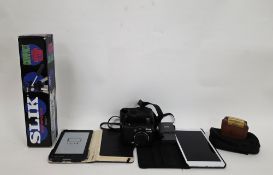Kindle 4th generation model D01100 together with a collection of cameras and equipment including