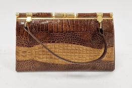 Mid-century crocodile skin handbag with gilt metal fittings opening to a stitched leather lined