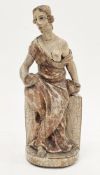 Wooden polychrome carving of a seated classical seated woman holding an apple and bowl, possibly the