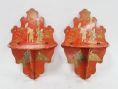Pair of Japanese red and gilt lacquered folding wall shelves, each of scroll outline, early 20th