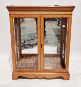Veneered display cabinet with carved dentil cornice over two etched glazed doors opening to a