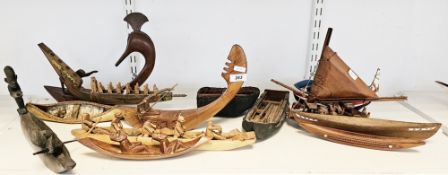Collection of twelve ethnic and tribal model boats including African fisherman's pirogue boat with