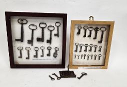 Two framed, glazed and mounted displays of 18th century keys, the first holding eleven door,