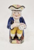 English pottery Toby jug, circa 1820-40, modelled seated holding a jug and goblet, pierced hat and