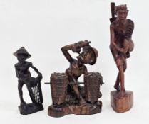 Ida Bagus Tilem (Indonesian 1936-1993), a hardwood carving of a seated man drinking from a flask