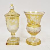 Late 19th century Bohemian amber flashed and engraved goblet and cover and a flared footed vase, the