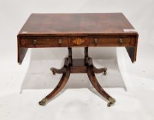 Regency rosewood and satinwood crossbanded sofa table, the drop flaps with canted corners, two