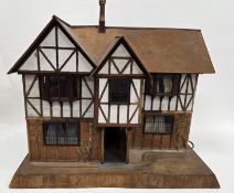 Bespoke half-timbered Tudor-style dolls' house, 1930s, the exterior with 2 hinged openings to each