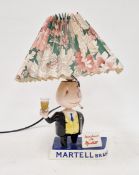 Carlton Ware Martell Brandy advertising table lamp, with a smoking figure standing before a sign