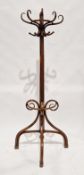 Early 20th century bentwood hat, coat and stickstand of demi-lune form with label to verso for the