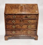 George III walnut veneer and cross-banded bureau, the sloping fall front opening to an interior