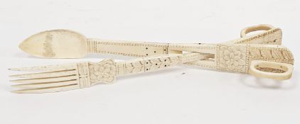 19th century carved bone scrimshaw serving tongs, carved with stiff leaves and flowerheads, 31 cm