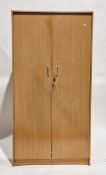 Mid-century Lebus pale teak wardrobe, the two doors opening to a hanging compartment, with key,
