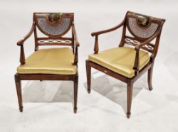 Pair of Edwardian painted satinwood bergere armchairs in the Sheraton manner, the oval back panels