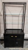 Pair of French display cabinets designed by Pierre Vandel, having a black lacquered and gilt metal