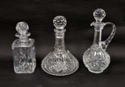 Three modern cut-glass decanters and stoppers, comprising: a square section whisky decanter and