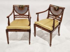 Pair of Edwardian painted satinwood bergere armchairs in the Sheraton manner, the oval back panels