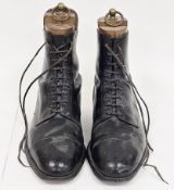 Pair of early 20th-century ankle-length lace-up black leather boots, steel capped heels, inserted