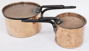 Two early 20th-century French copper saucepans with lids and iron handles, one stamped La Croix