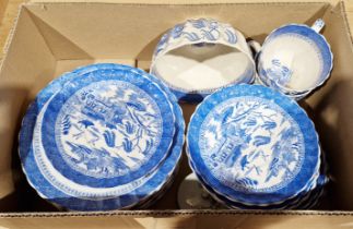Blue and white willow pattern part tea set comprising cake plates, saucers, sugar bowl etc.