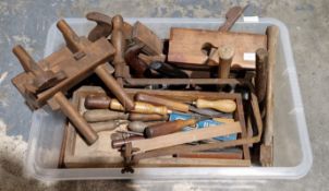 Collection of woodworking tools including metal and wooden woodworking planes, wooden handled