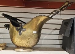 Brass helmet-shaped coal scuttle, two brass fire irons and a wrought iron folding firescreen with