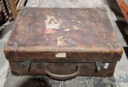 Early 20th century leather suitcase with the remnants of luggage labels, 57cm wide and another
