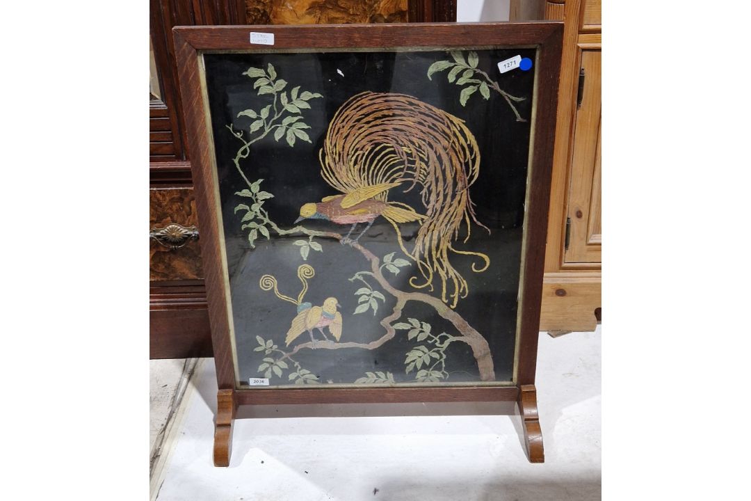 Early 20th century oak framed firescreen having a needlework panel decorated with exotic birds - Image 1 of 3
