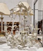 Metal five-branch chandelier having a cream and gilt distressed finish, the foliate decoration