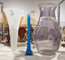 Three large glass vases inculding a blue tapered stem vase, a large purple baluster vase and a white
